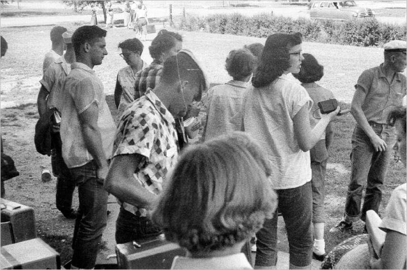 In the shade, waiting for rides, some in the background lugging luggage.  A great trip!!!  